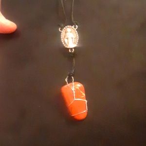 Rosary pendant with a hanging polished jasper gemstone on black hemp cord